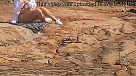 a beautiful young girl is WATCHED having sex in public on the beach rocks and INTERRUPTED by a third individual