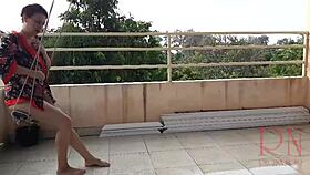 Depraved housewife swings naked under an umbrella in the rain. Full retro video of wild antics!