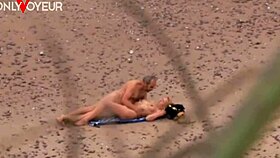 An older guy spots a hot milf flashing on the beach, then they fuck passionately as exhibitionists on the ocean shore