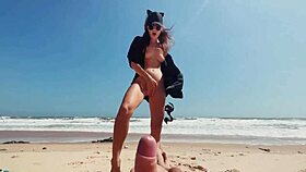 Teen girl openly masturbates on nude beach, stroking feet while guy jerks off