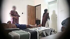 In the hotel, he flashes his cock to two maids during a massage session