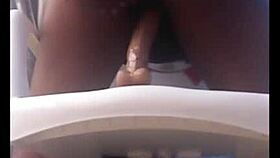 Intriguing ebony girl rides dildo on chair, teasing with big ass toys