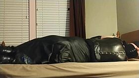 crossdresser self-bonds in heels and leather boots, gagging and choking