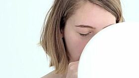 Young babe intensely blows and pops her first balloon