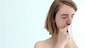 Young babe intensely blows and pops her first balloon