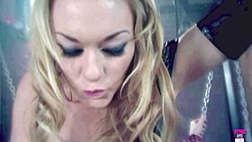 blonde sucking the dick of a tied up guy in bdsm mask