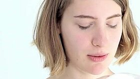 Young babe intensely blows and pops her first balloon