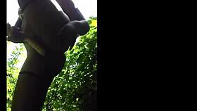 Flexible ebony shows off legs in outdoor gym session