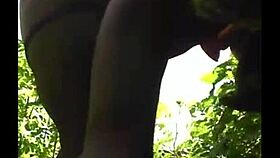 Flexible ebony shows off legs in outdoor gym session