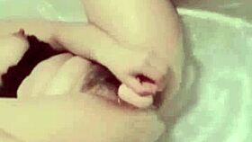 In the bathroom, the naughty sister watches porn and uses a dildo to masturbate to orgasm.