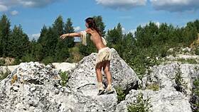 She dances topless in the quarry.