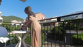 Nude on a public balcony, flashing my body over the busy road below