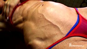 muscular bodybuilder performs dance in bikini and thong