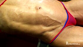 muscular bodybuilder performs dance in bikini and thong