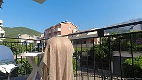 Nude on a public balcony, flashing my body over the busy road below