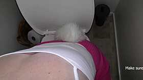 A woman with a buttplug gets her tail pinned and pisses while sucking master's cock