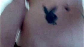 Inked crossdresser performing solo on webcam