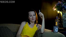 brunette sucks on cigarette while gazing voyeuristically at you