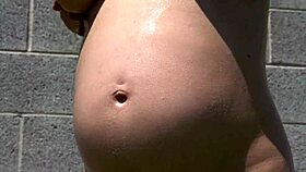 9 months pregnant and oiled up for outdoor sex in the garden