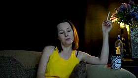 brunette sucks on cigarette while gazing voyeuristically at you