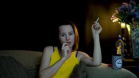 brunette sucks on cigarette while gazing voyeuristically at you