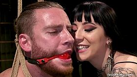 tattooed femdom directs man in action