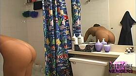 Sexy brunette shaves legs in shower