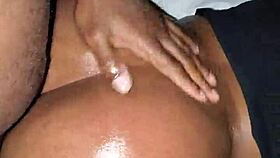 Ebony woman bent over in oiled doggystyle position with moaning