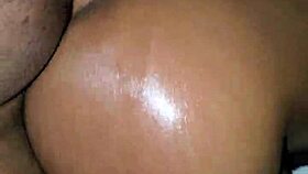 Ebony woman bent over in oiled doggystyle position with moaning