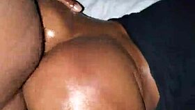 Ebony woman bent over in oiled doggystyle position with moaning