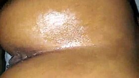 Ebony woman bent over in oiled doggystyle position with moaning