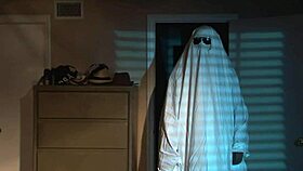 A sexy nude girl celebrates Halloween in bed.