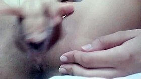 Solo babe masturbates shaved pussy to orgasm in close up detail.