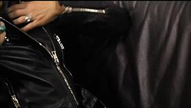 The rock chick poses in leather pants and biker jacket.