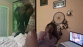 Naejae is rubbing her wet pussy while watching lesbian porn on the screen.