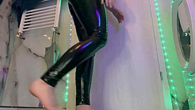 The teen amateur masturbates and uses a big dildo in latex leather.