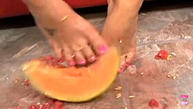 brunette with tattoos squishes melon with feet then gets doggy fucked