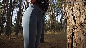 Hey, see this hot milf in tight jeans teasing her ass outdoors in woods