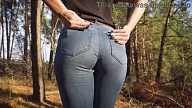 Hey, see this hot milf in tight jeans teasing her ass outdoors in woods
