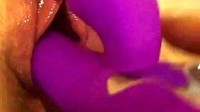 Tight pussy fucked by pink toy on bed