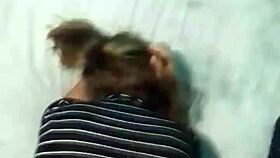 In a homemade webcam setup, a Latina emo milf shares a POV moment on a big bed using a notebook for connection.