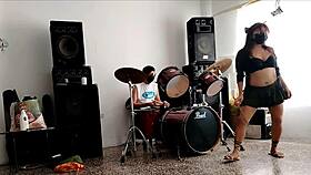 She strips and dances, showing her curvy ass for their drum beats.