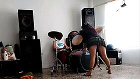 She strips and dances, showing her curvy ass for their drum beats.