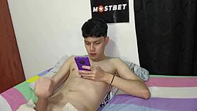 Young Colombian guy jerks off to porn on his phone, and his hot stepmom helps out 😏