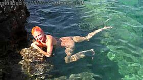 Blue water surrounds a naked skinny girl flashing outdoors