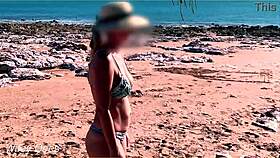wifey shows off her big tits while flashing at the beach in a bikini