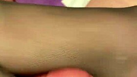 giving the hubby a foot massage in black reinforced toe stockings