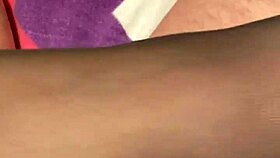 giving the hubby a foot massage in black reinforced toe stockings