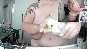 Chubby woman does dishes naked with saggy tits exposed