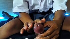 Asian schoolgirl teases and jerks cock in amateur video